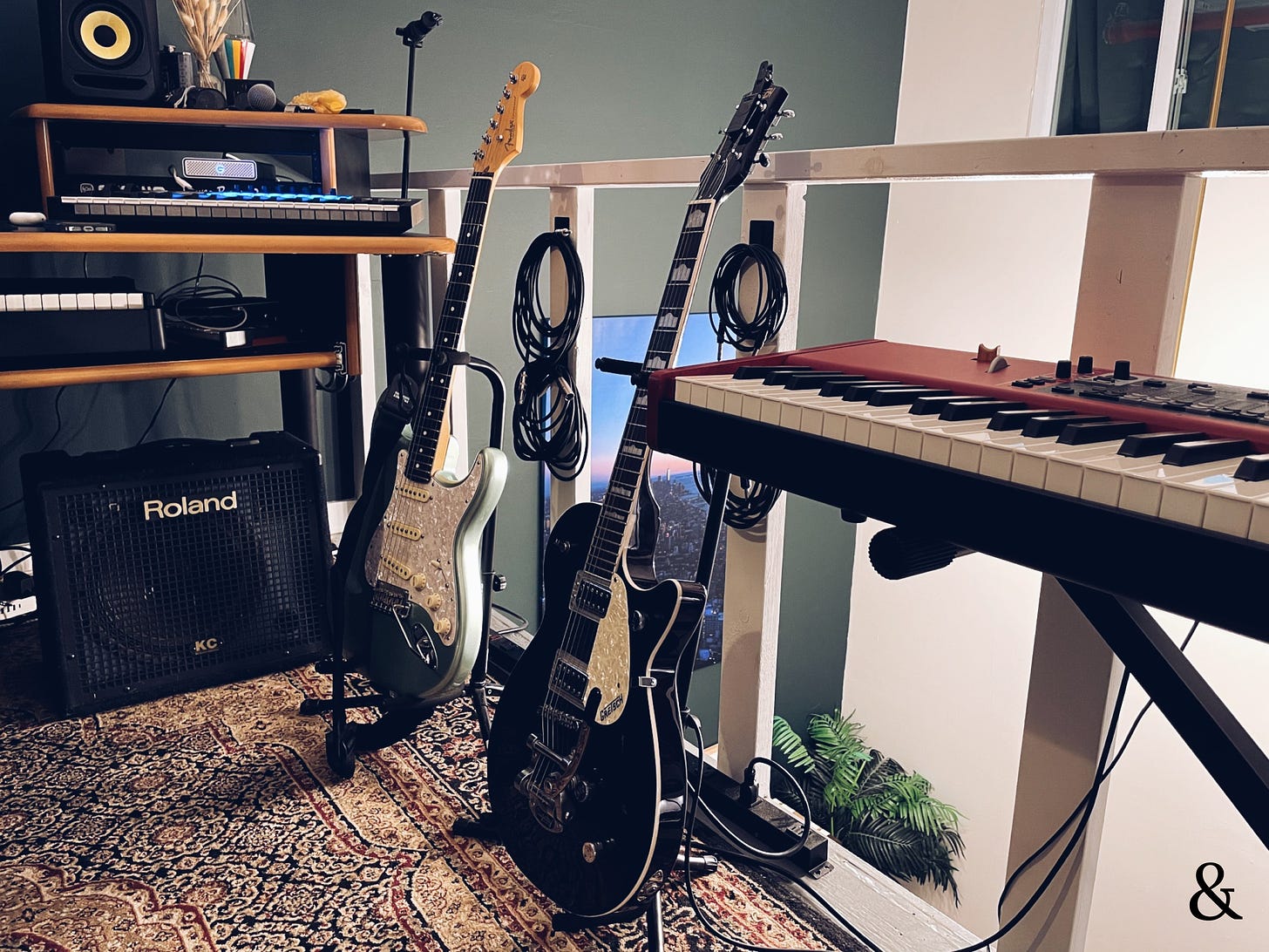 Two guitars, keyboards, and speakers.