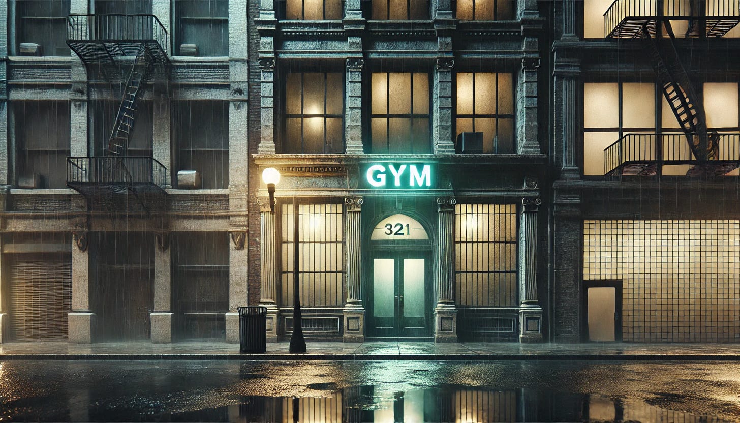 A detailed and atmospheric image of the façade of an old gym on a rain-soaked city street at night. The gym is framed by two weathered, aging buildings. The entrance features a flickering neon sign with a faint green glow, reflecting on the wet pavement below. Streetlights cast a dim light that mixes with shadows and rain, creating an eerie and melancholic mood. The exterior architecture is gritty, with cracked bricks and rain streaks on the walls. No interior or weights are visible, focusing entirely on the urban street scene and the gym's entrance.