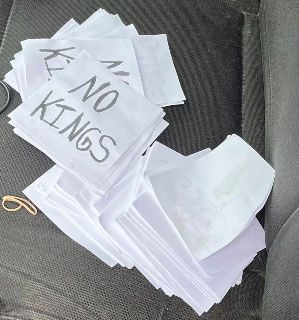Stack of papers with "No Kings" written on several.