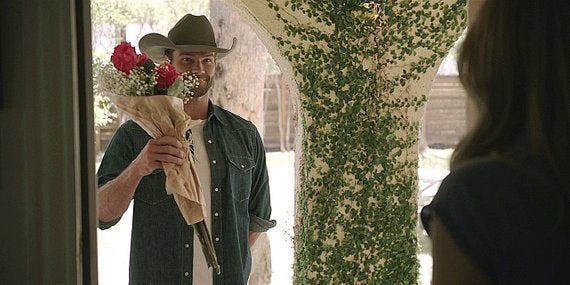 Cordell holding up bunch of roses to Twyla on her doorstep with Walker Torn.