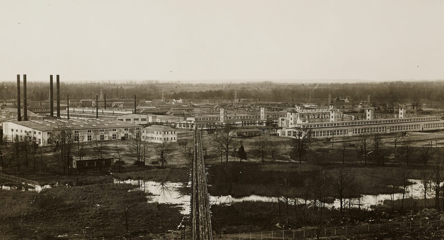 A black and white photo showing a large area of industrial buildings.