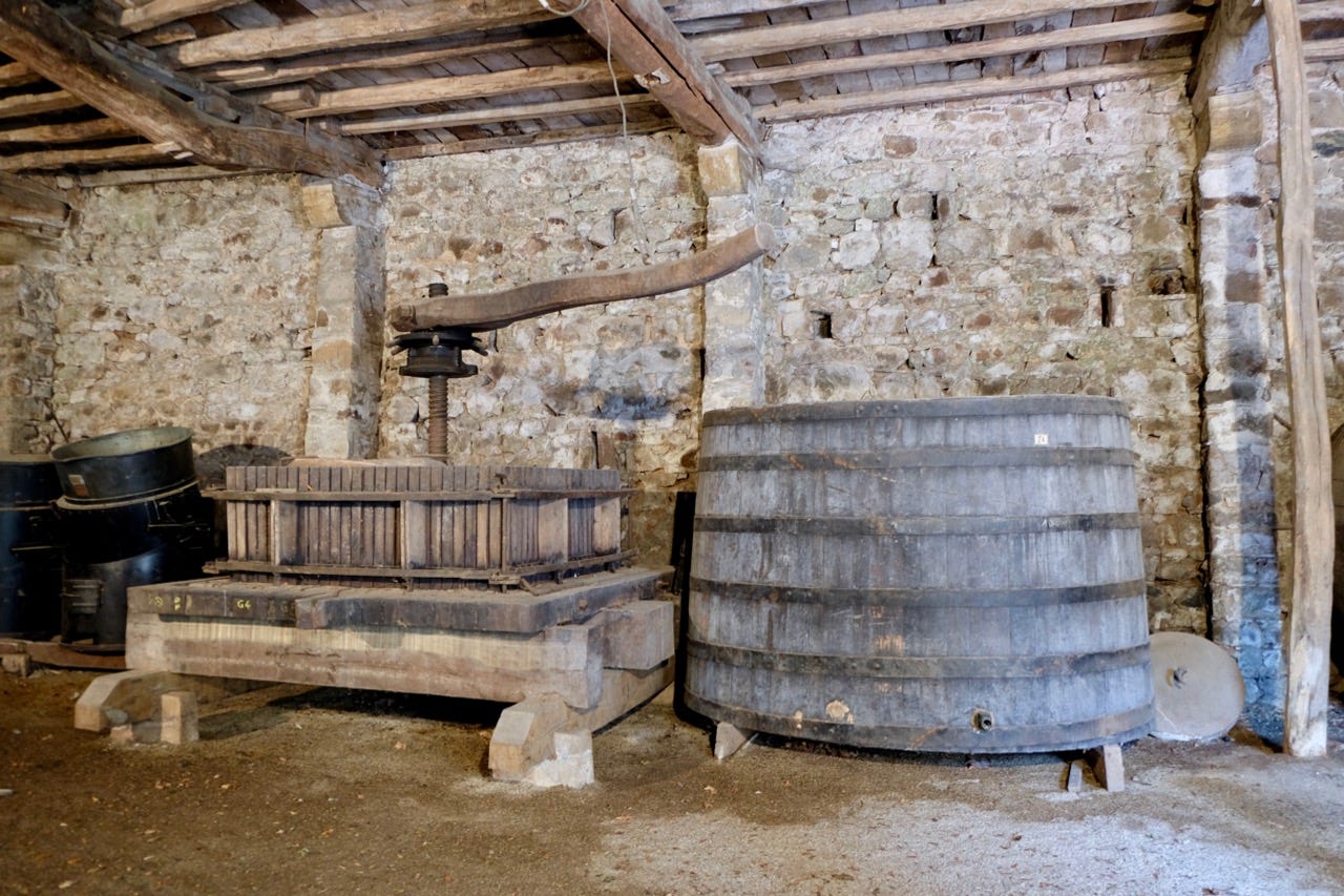 Historic press and tank at Château de Poncié