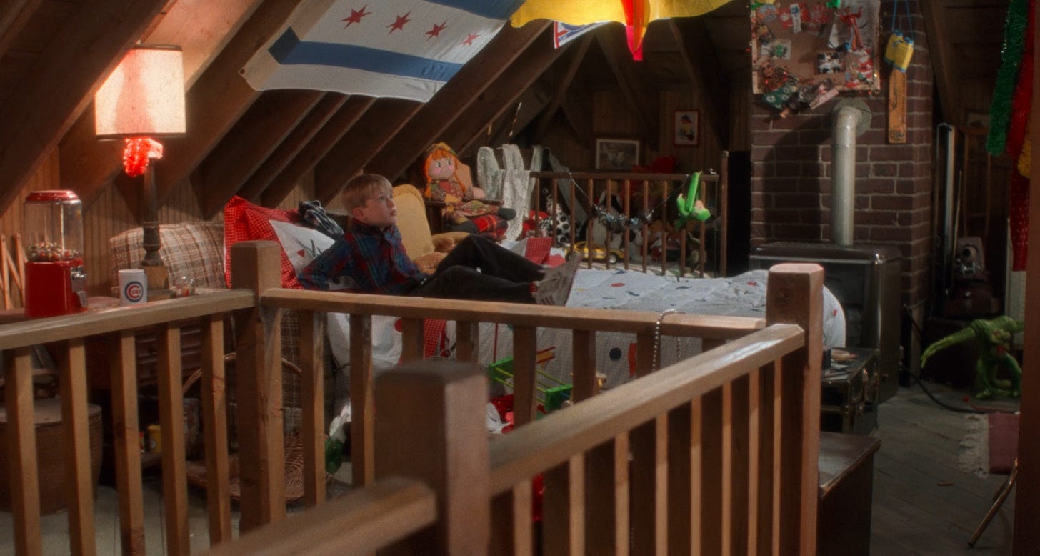 Screenshot of Kevin McAllister in bed in the attic. It has exposed rafters and toys and junk around.