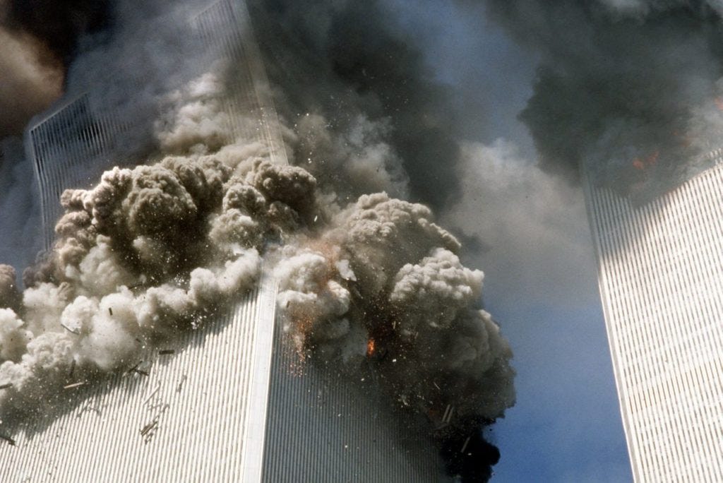 The south tower of the World Trade Center, left, begins to collapse after a terrorist attack on the landmark buildings in New York, Tuesday, Sept. 11, 2001. (AP Photo/Gulnara Samoilova)