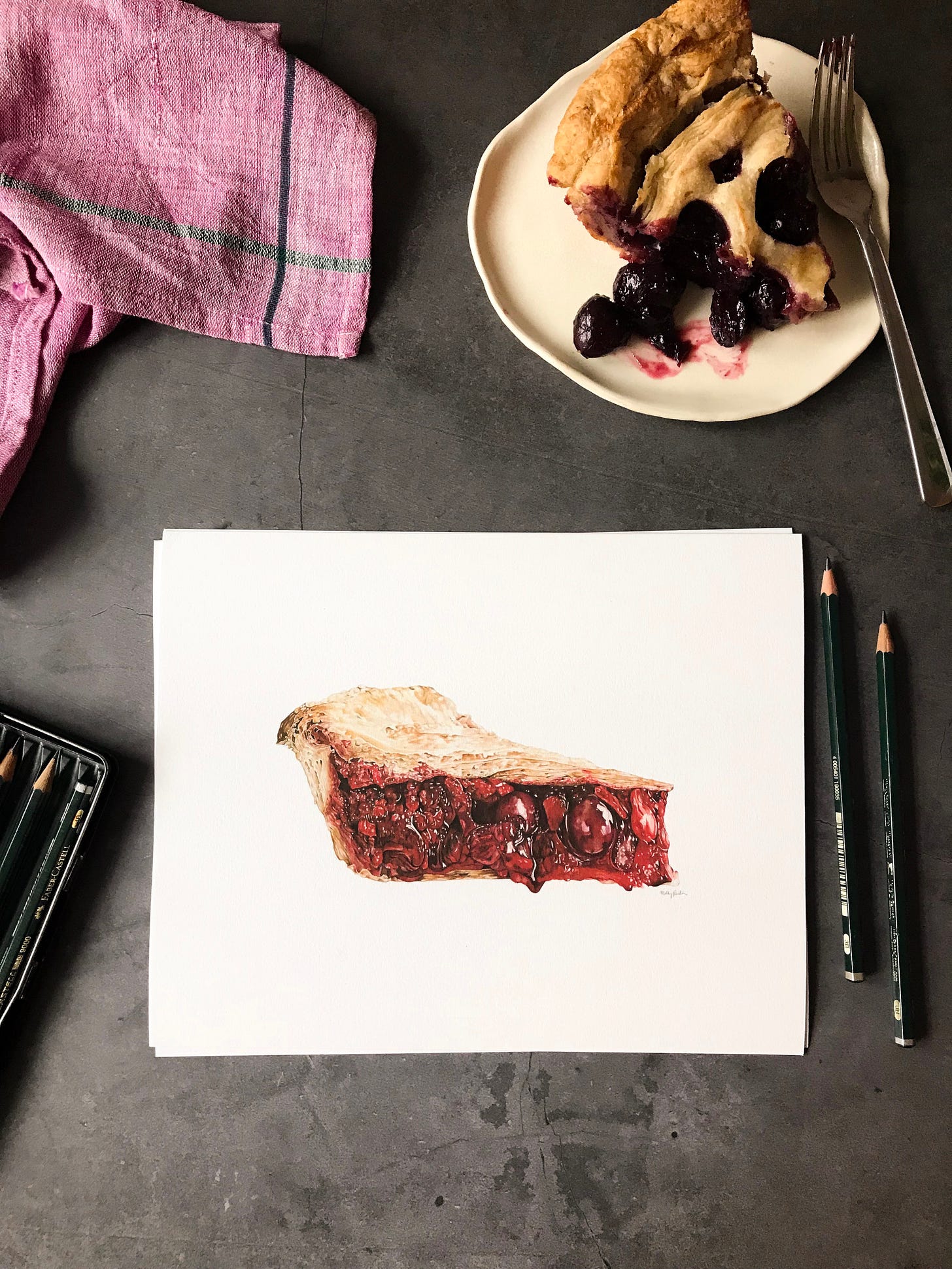 A photo of an 8x10" cherry pie print, with a real slice of cherry pie to the right top corner