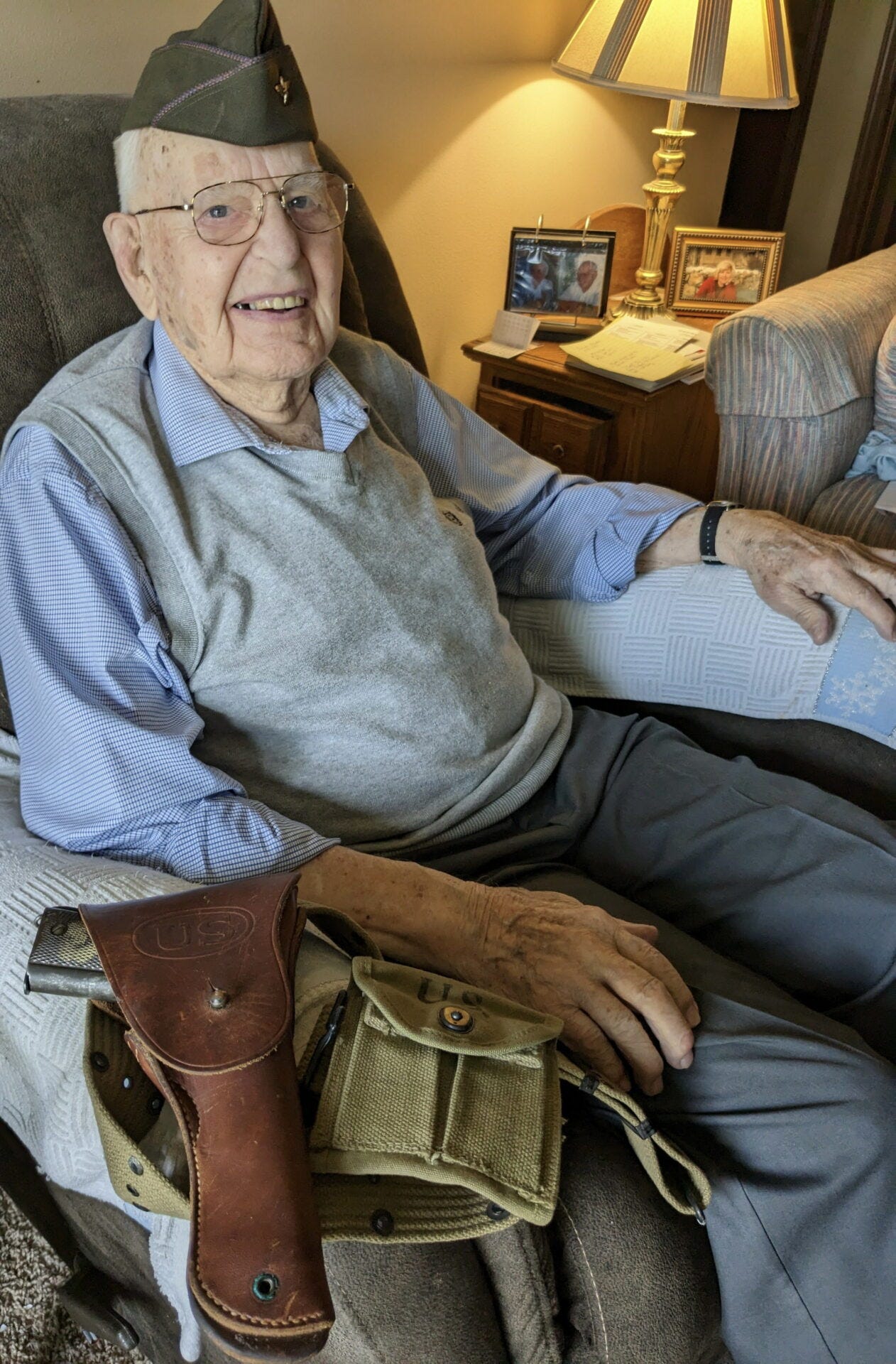 Percy Grote of Aberdeen poses for a photo with World War II artifacts, including the cap he wore while serving in the U.S. Army Air Corps. Aberdeen Insider photo by Scott Waltman