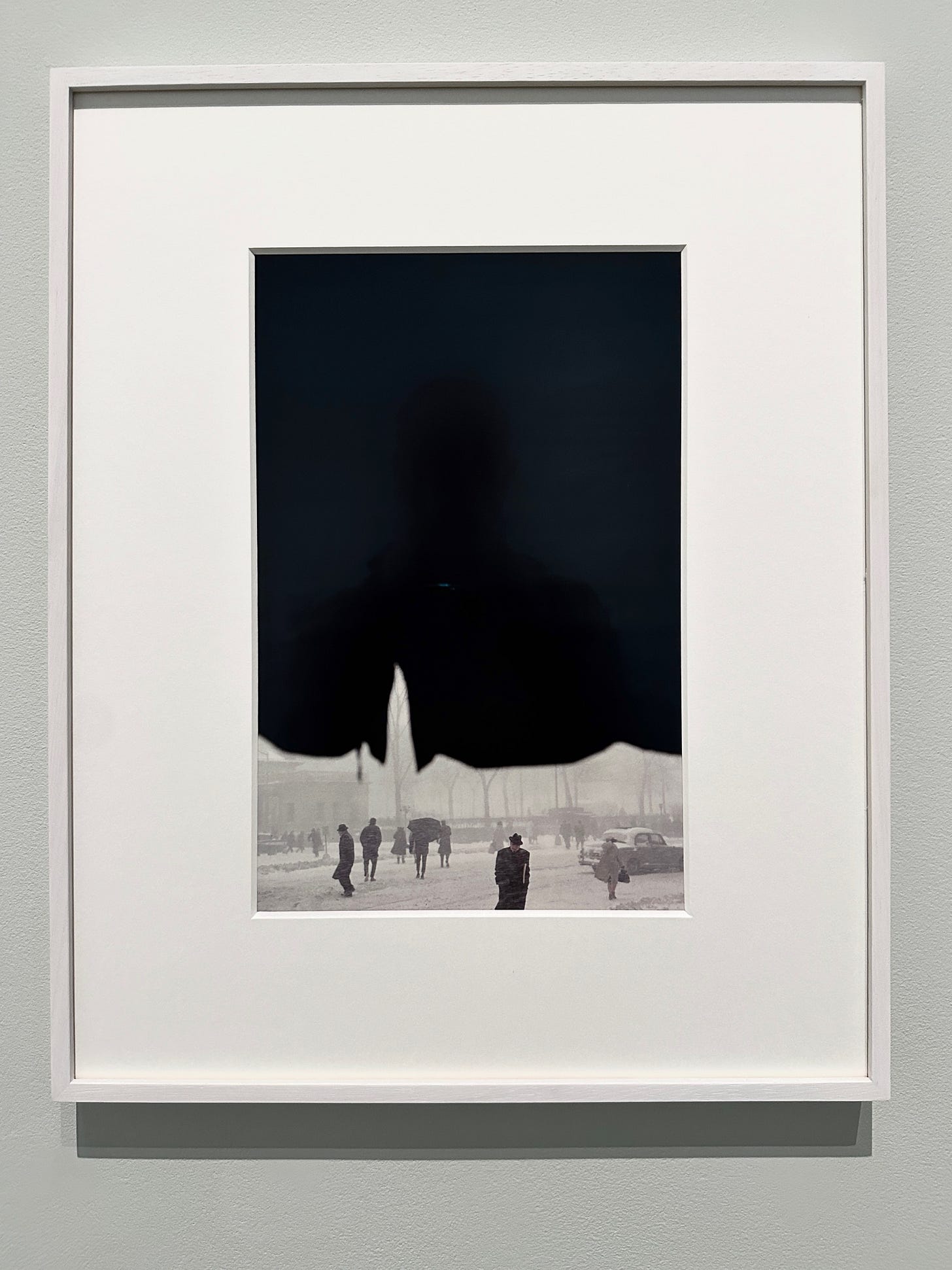 A framed picture of a person's shadow

Description automatically generated
