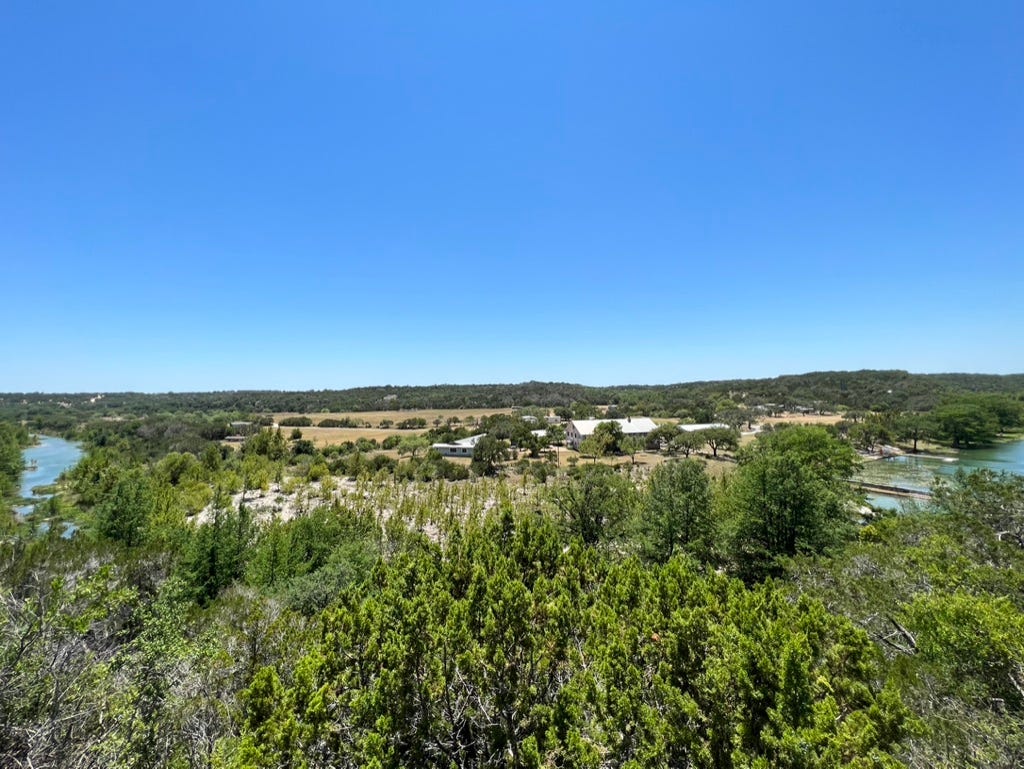 A landscape with trees and a blue sky

Description automatically generated