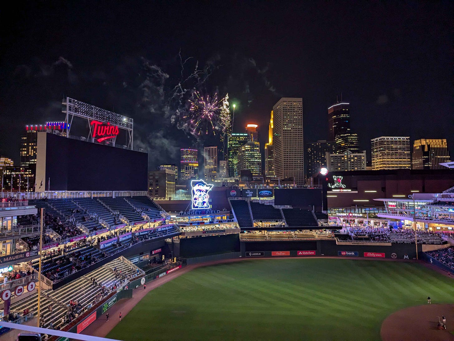 Target Field at night, with Bullseye visible across the street at Target Center.