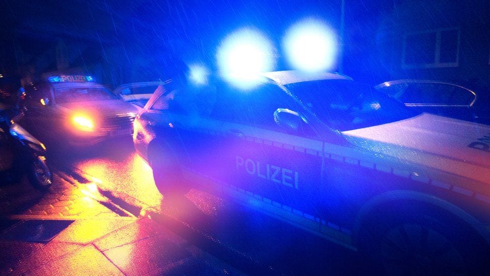 German police cars on the road at night