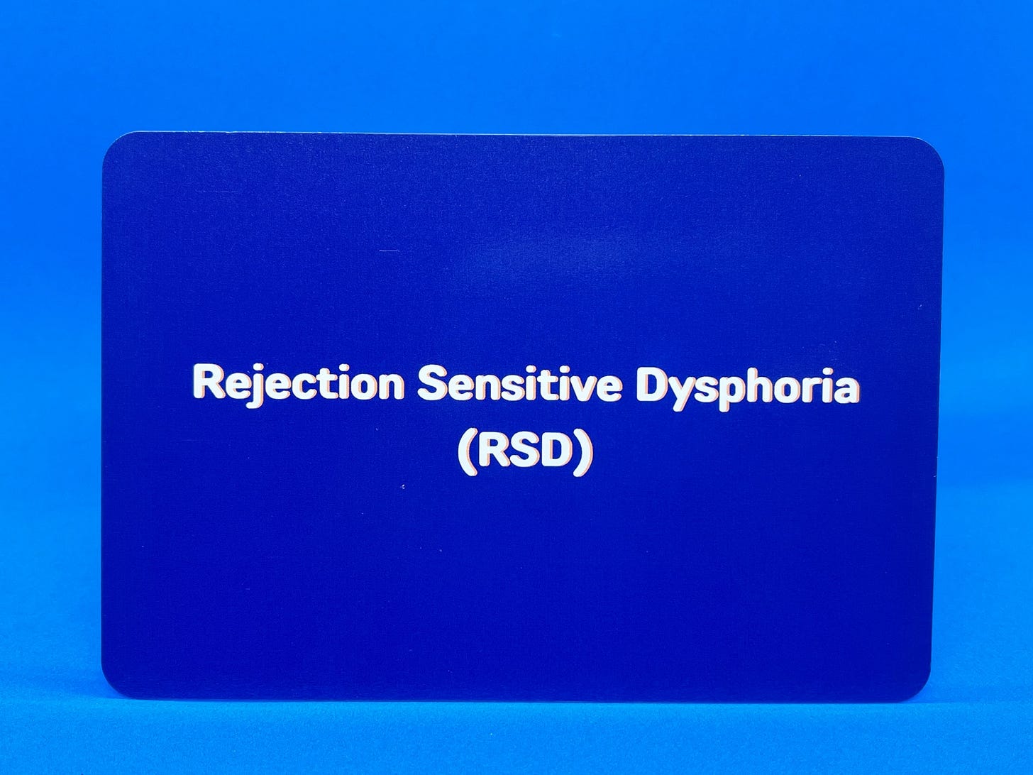 A dark blue flashcard with this text written on it: 'Rejection Sensitive Dysphoria (RSD)