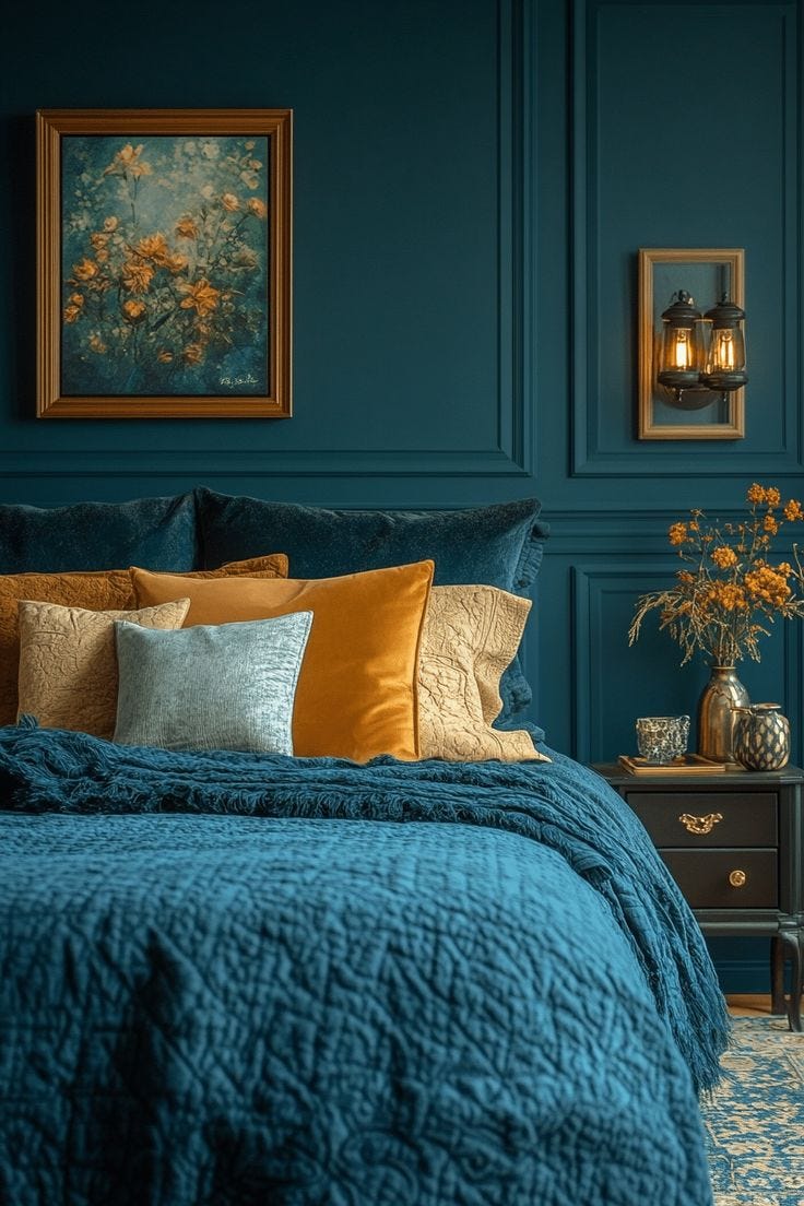 This may contain: a bedroom with blue walls and gold pillows