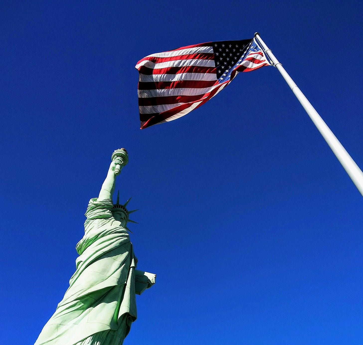 US flag and the Statue of Liberty US flag and the Statue of Liberty