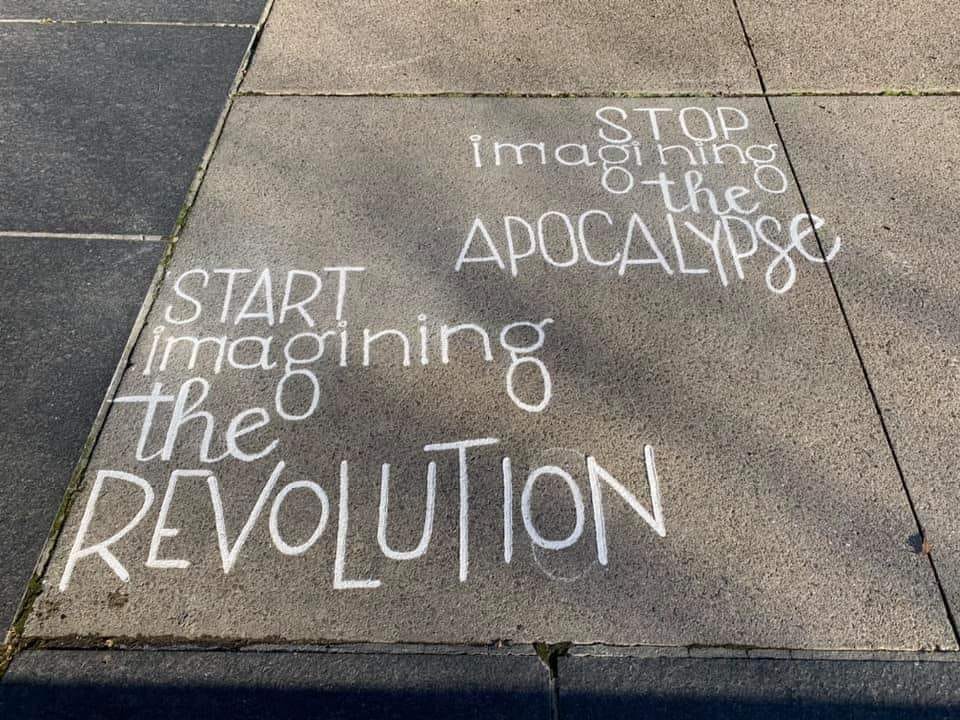 sidewalk with writing on it: Stop imagining the apocalypse and start imagining the revolution