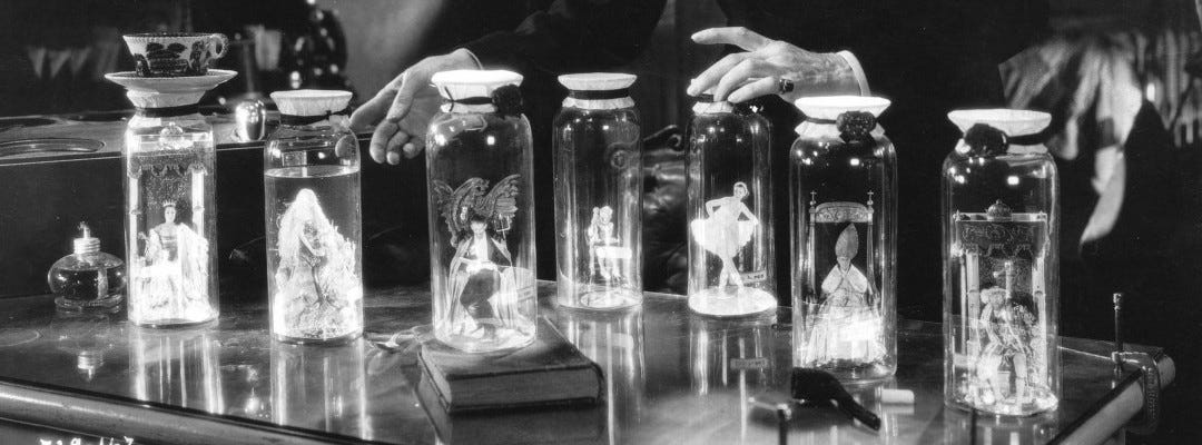 Seven tiny people in glass jars - from the 1935 film Bride of Frankenstein: a king modelled o Henry VIII, a queen played by Joan Woodbury, a ballerina, a devil, a bishop, a mermaid and a little boy