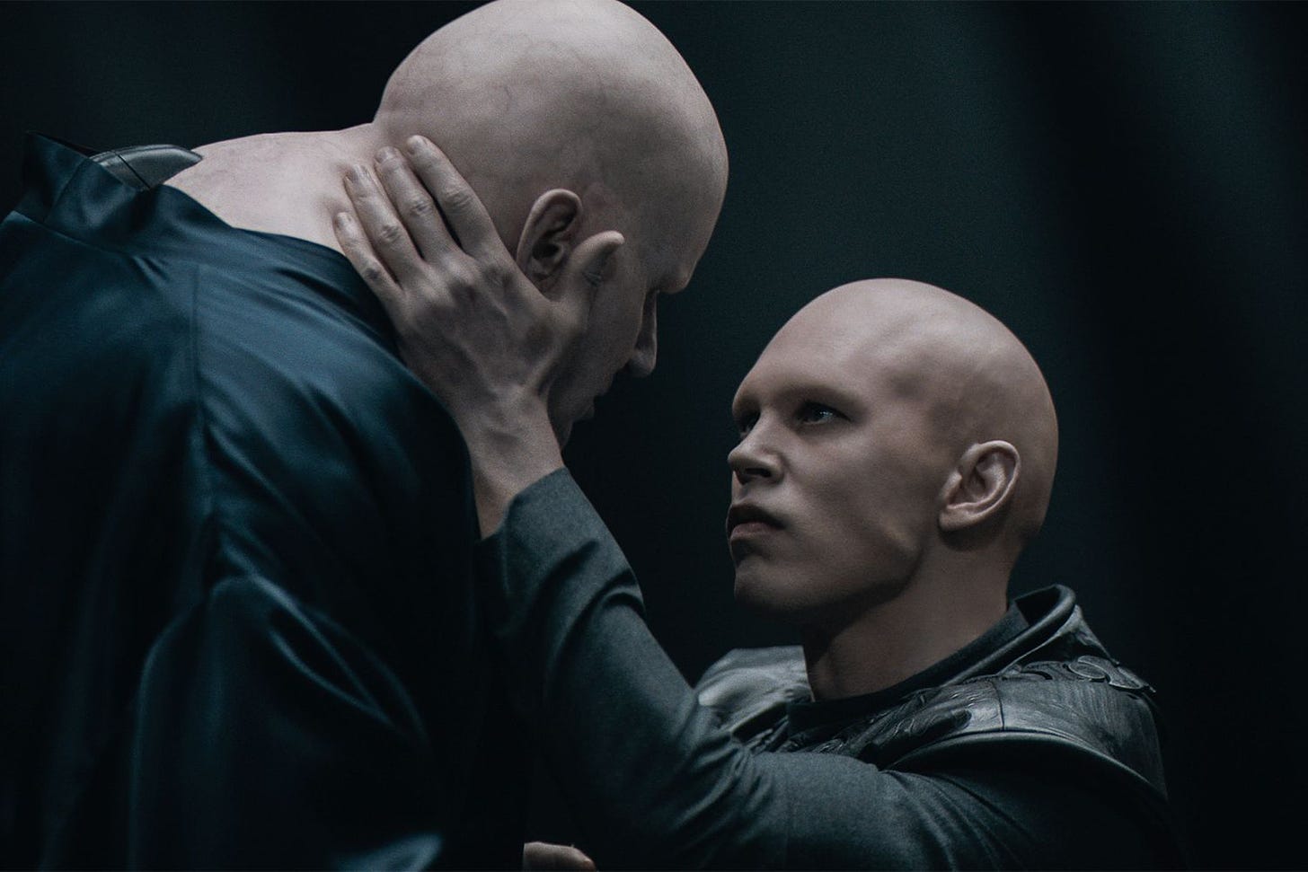 Austin Butler, very bald as Feyd Rautha, goes in for a kiss with his uncle Baron Harkonnen (also bald) in Dune: Part Two.