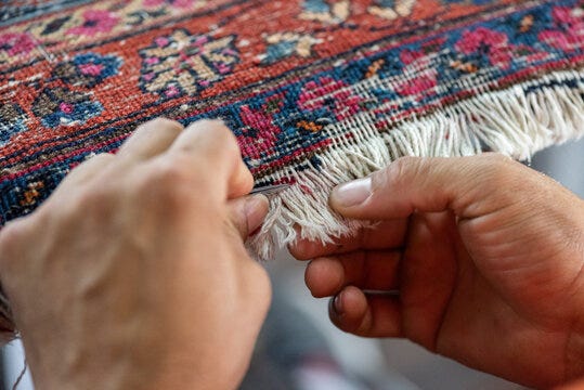 traditional hand sewing fixing old vintage antique persian carpet up close  foto de Stock | Adobe Stock