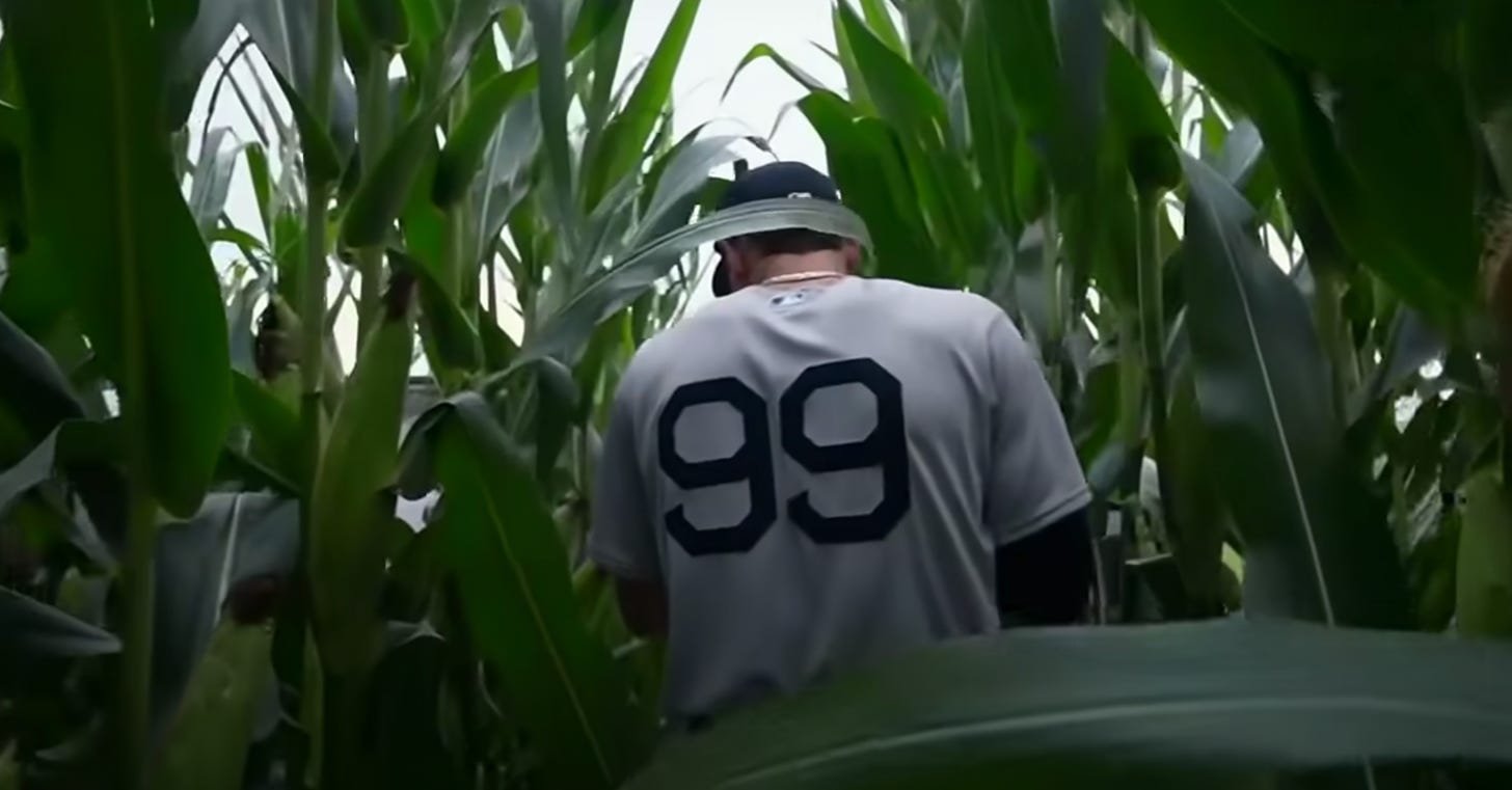 Aaron Judge viewed from behind with number 99 on his jersey walking out of Iowa cornfield 