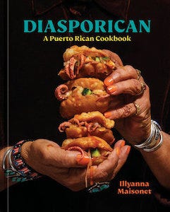 cover of Diasporican: A Puerto Rican Cookbook by Illyanna Maisonet, showing a pair of brown-skinned hands wearing colorful bracelets and silver rings holding up four squid-stuffed arepas