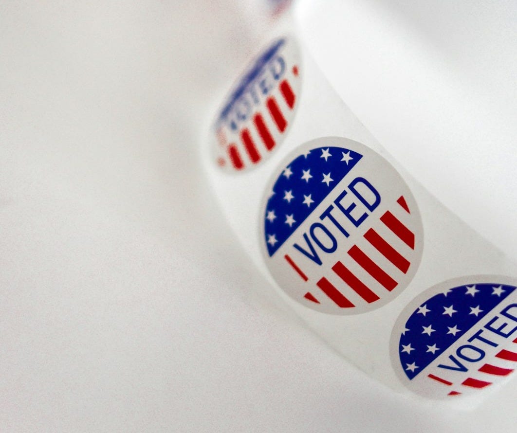 a close up of a toothbrush with the word vote written on it