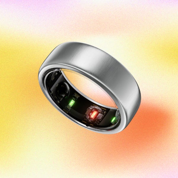 A silver smart ring on a gradient background