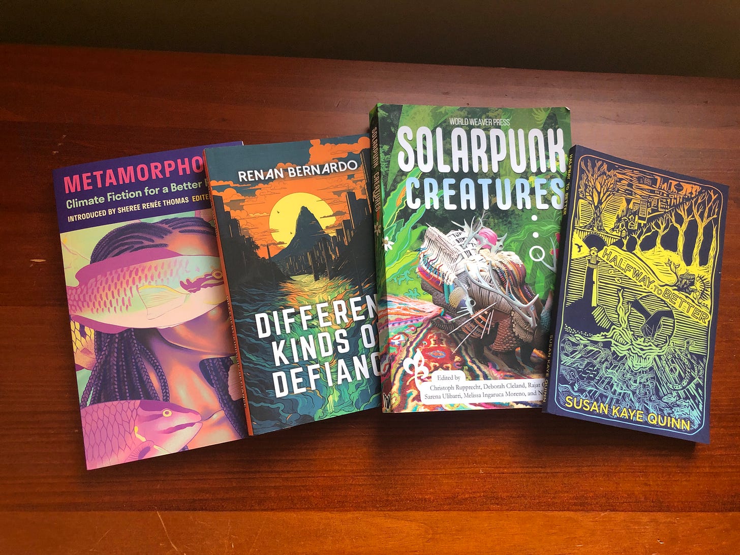 Four books: Metamorphosis, Different Kinds of Defiance, Solarpunk Creatures, Halfway to Better