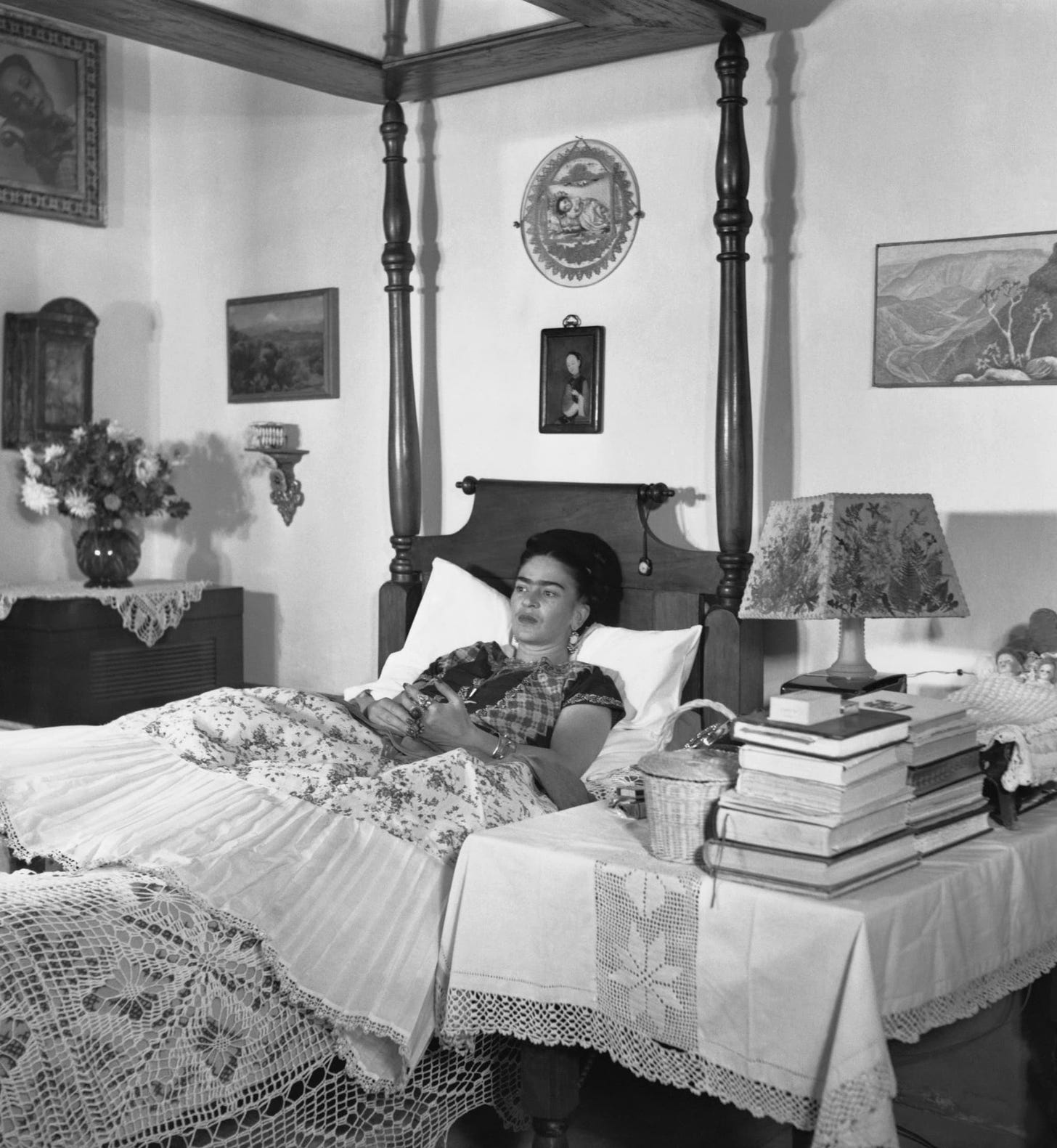A photograph of Frida Kahlo, in one of her bedridden states in her home in Mexico City