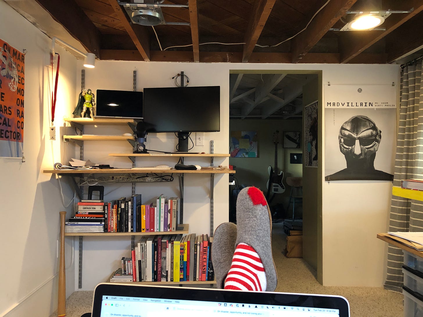 Office view of standing desk with bookshelves underneath