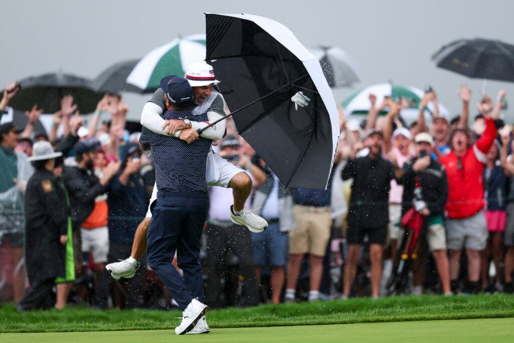 J.J Spaun celebrates with his caddie after making a putt on the 18th hole at the US Open J.J Spaun celebrates with his caddie after making a putt on the 18th hole at the US Open