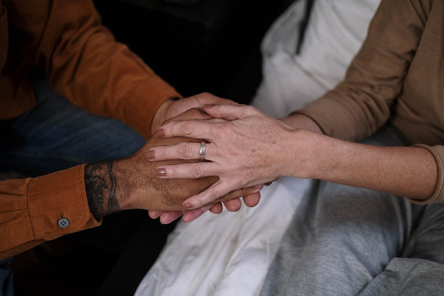 We All Need Help. Image of two people holding hands.
