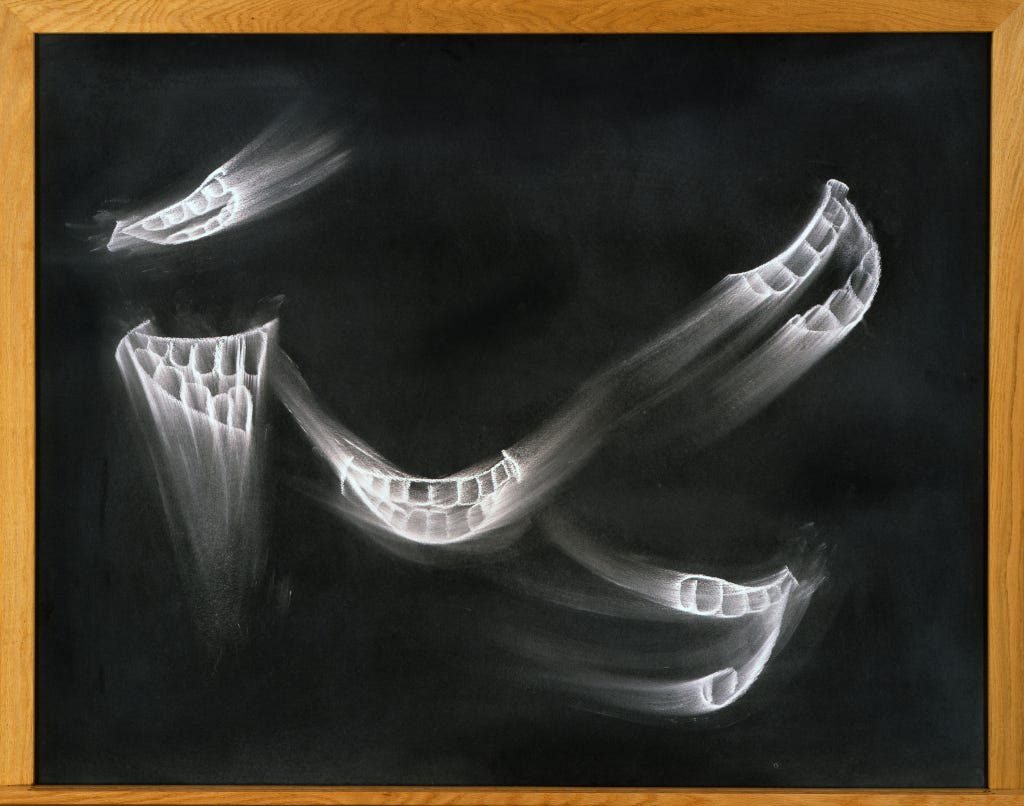 A series of smudged smiles on a black chalk board with a wooden border.