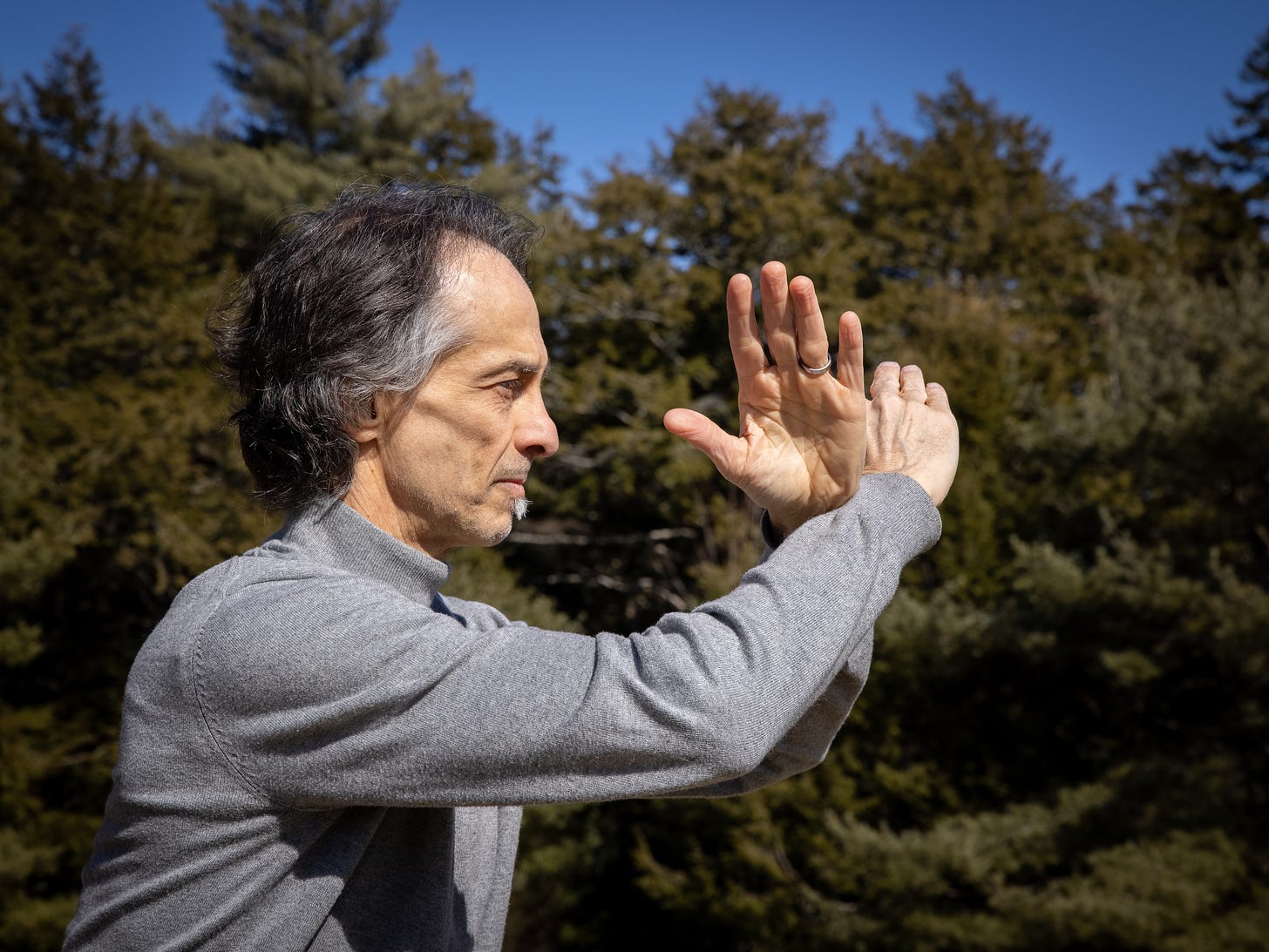 man doing Qi Gong outside