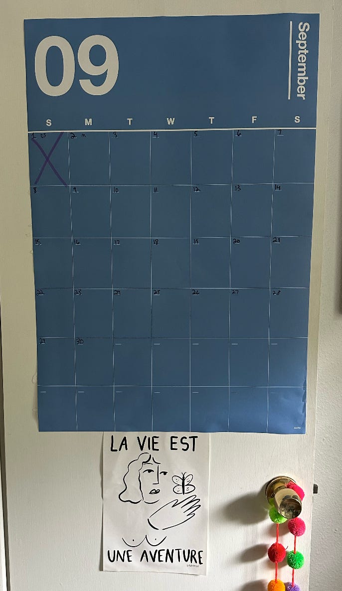 A blue September calendar on a closet door.