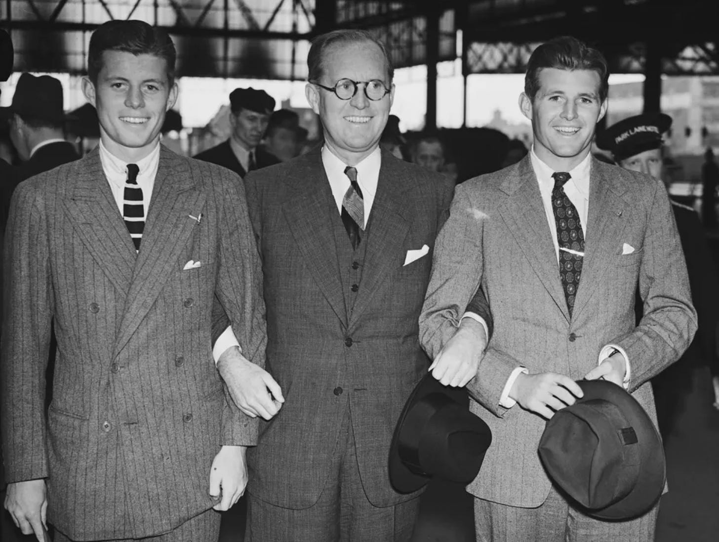 This black and white photo shows a young John F. Kennedy, Joseph P. Kennedy Sr. and Joseph P. Kennedy Jr. in London in 1937.