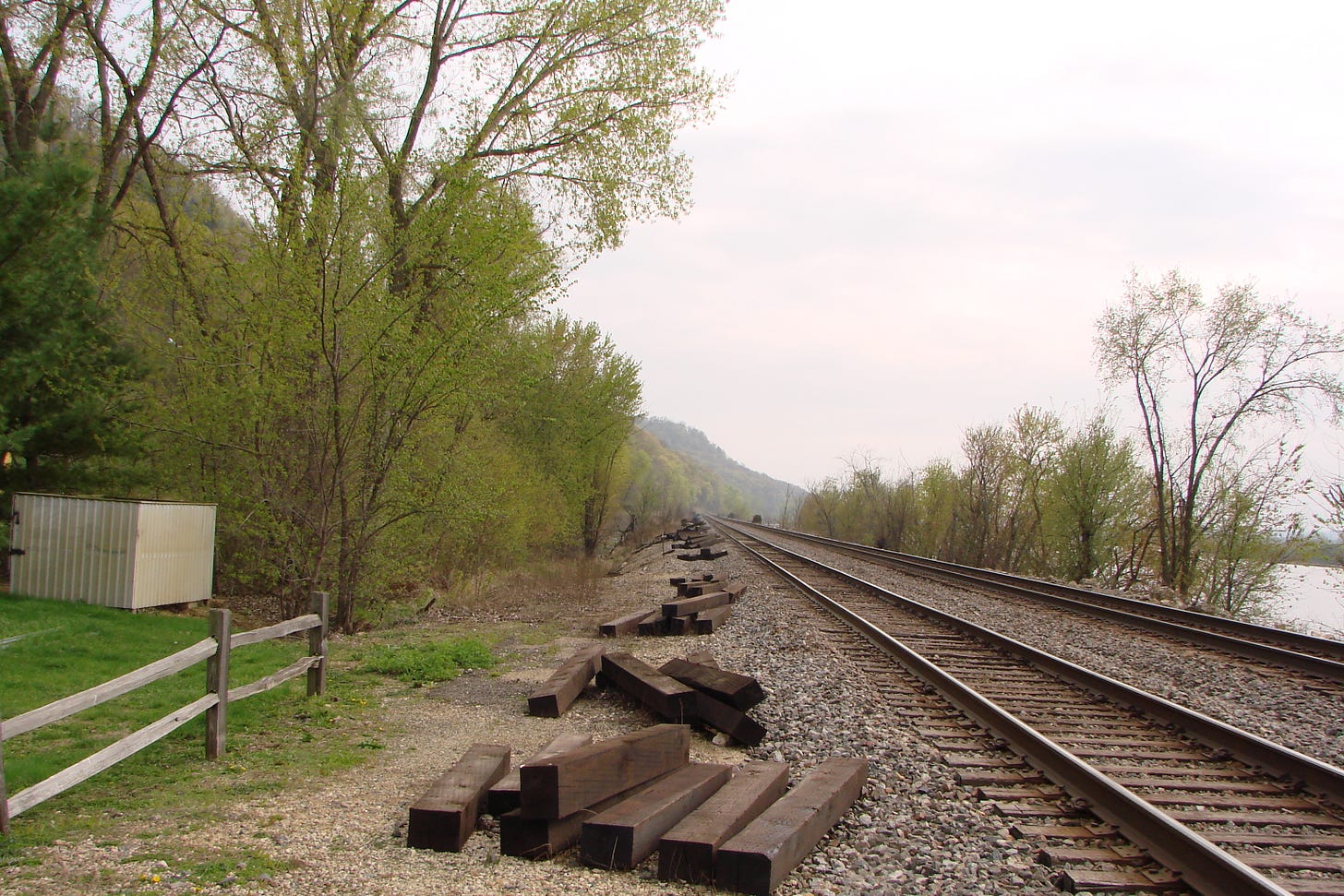 a photo of train tracks converging in the distance (start the journey)
