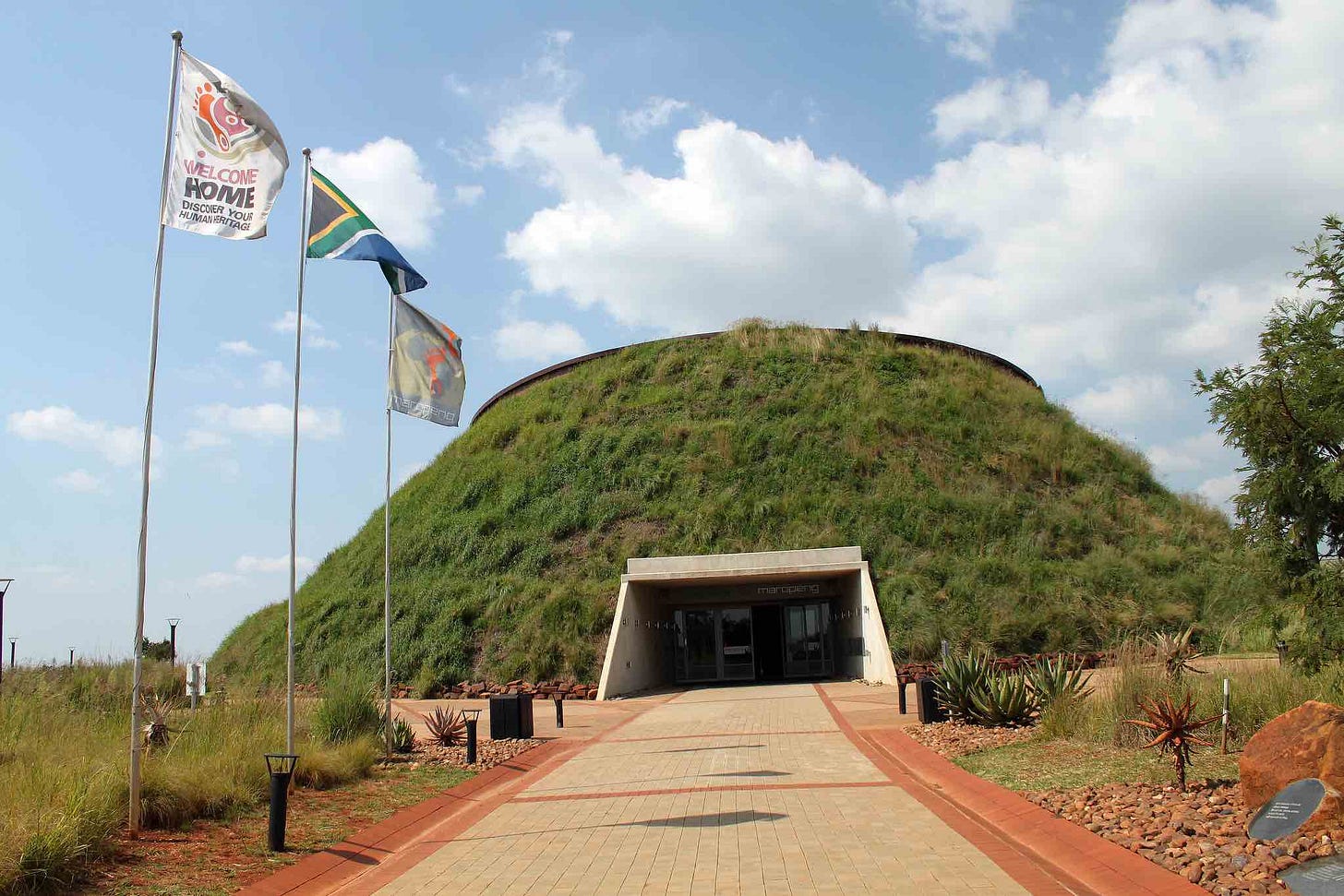 Maropeng Visitor Centre showing front view with grassy hill and door entering in.