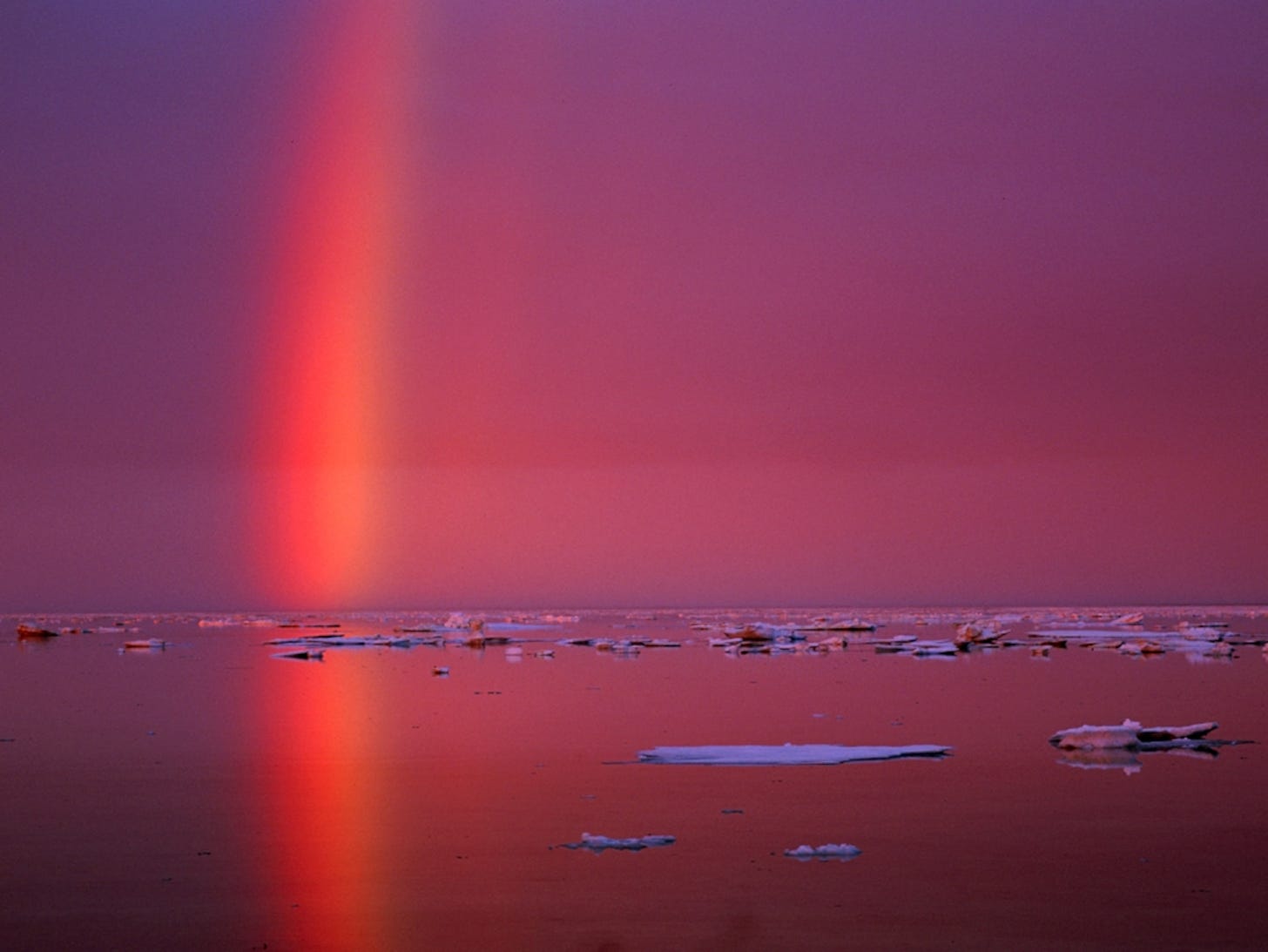 Rainbow reflected on icy waters