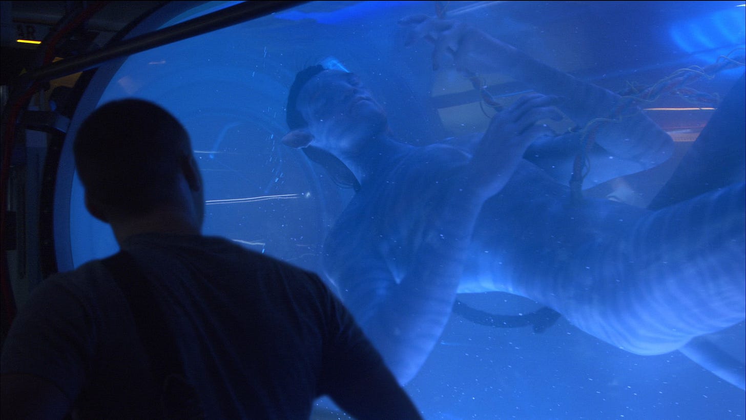 A Na'Vi from the film Avatar, floating in glass tube, unconscious