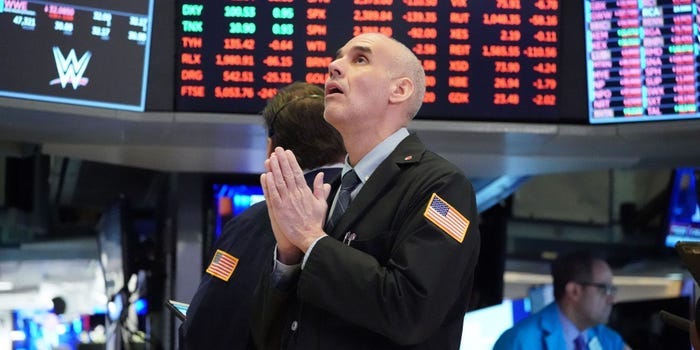 A trader with his hands together, looking worried.