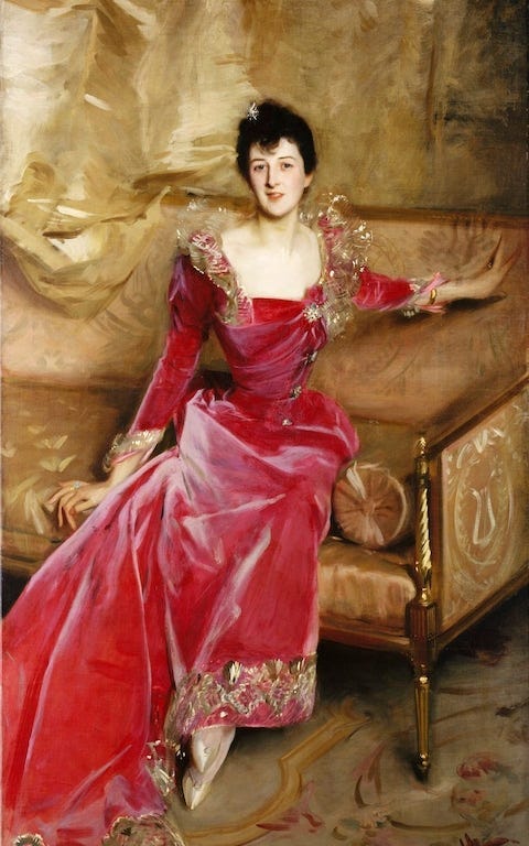Mrs. Hugh Hammersley (1892) in an exquisite late Victorian meets Elizabethan dress. It has a high lace collar drimmed with braid like a ruff, and pops with bright pink velver. The shirt and bodice are swathed in drapes of fabric. She leans forward breathlessly on a gold sofa — probably to tell us about he fabulous dress. A piece of fabric from the dress was lovingly preserved by the sitter’s sister.
