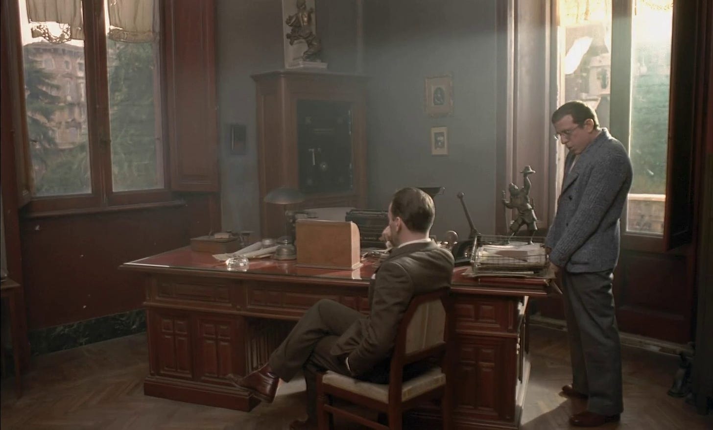 Jean-Louis Trintignant sits in a desk chair facing away from us in Bertolucci’s “The Conformist” (1970). 