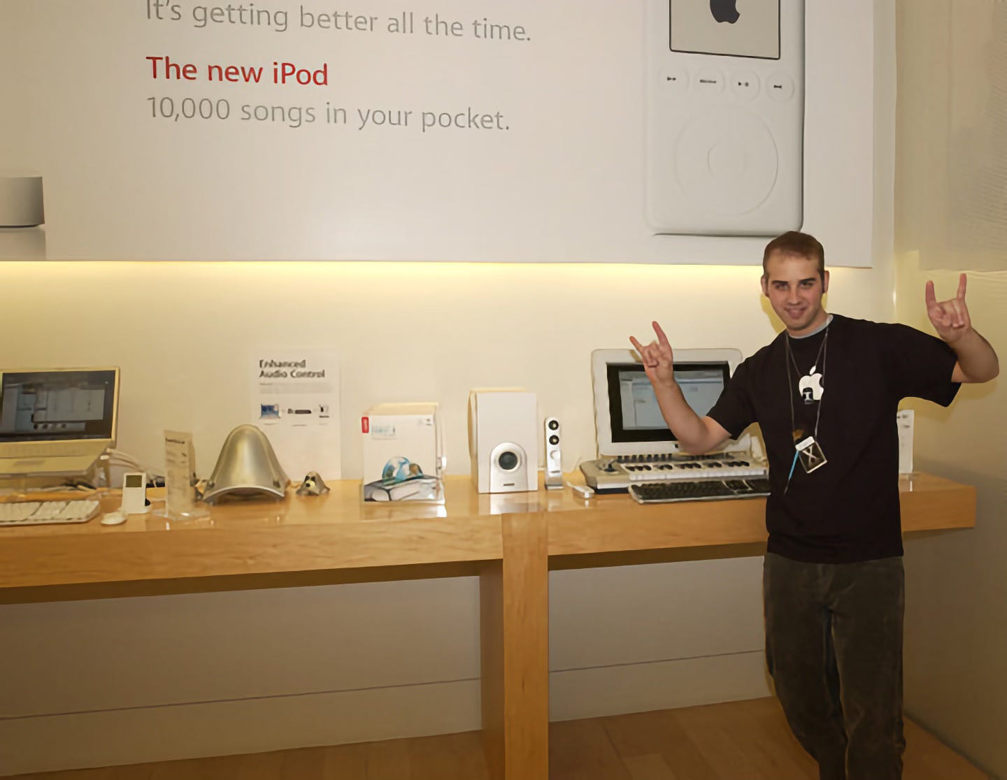 An employee poses in front of Apple Store Macs during Night of the Panther.