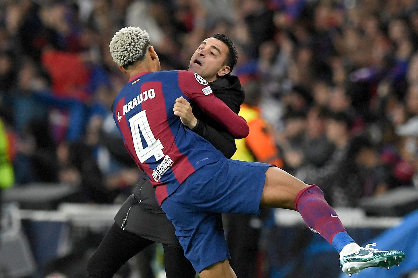 Barcelona manager Xavi Hernandez pictured hugging Ronald Araujo during a game against PSG in April 2024