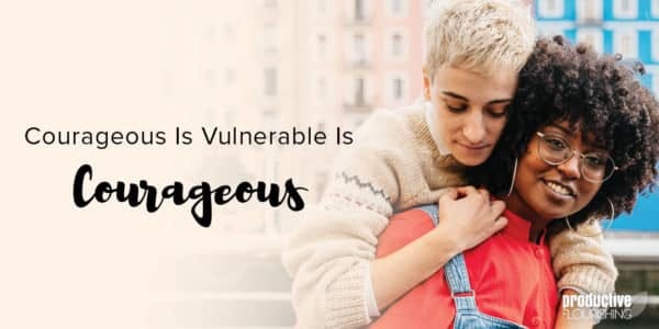 Two people stand together, one with short blonde hair in a white sweater hugs the other, who has a red shirt on. Text overlay: Courageous Is Vulnerable Is Courageous