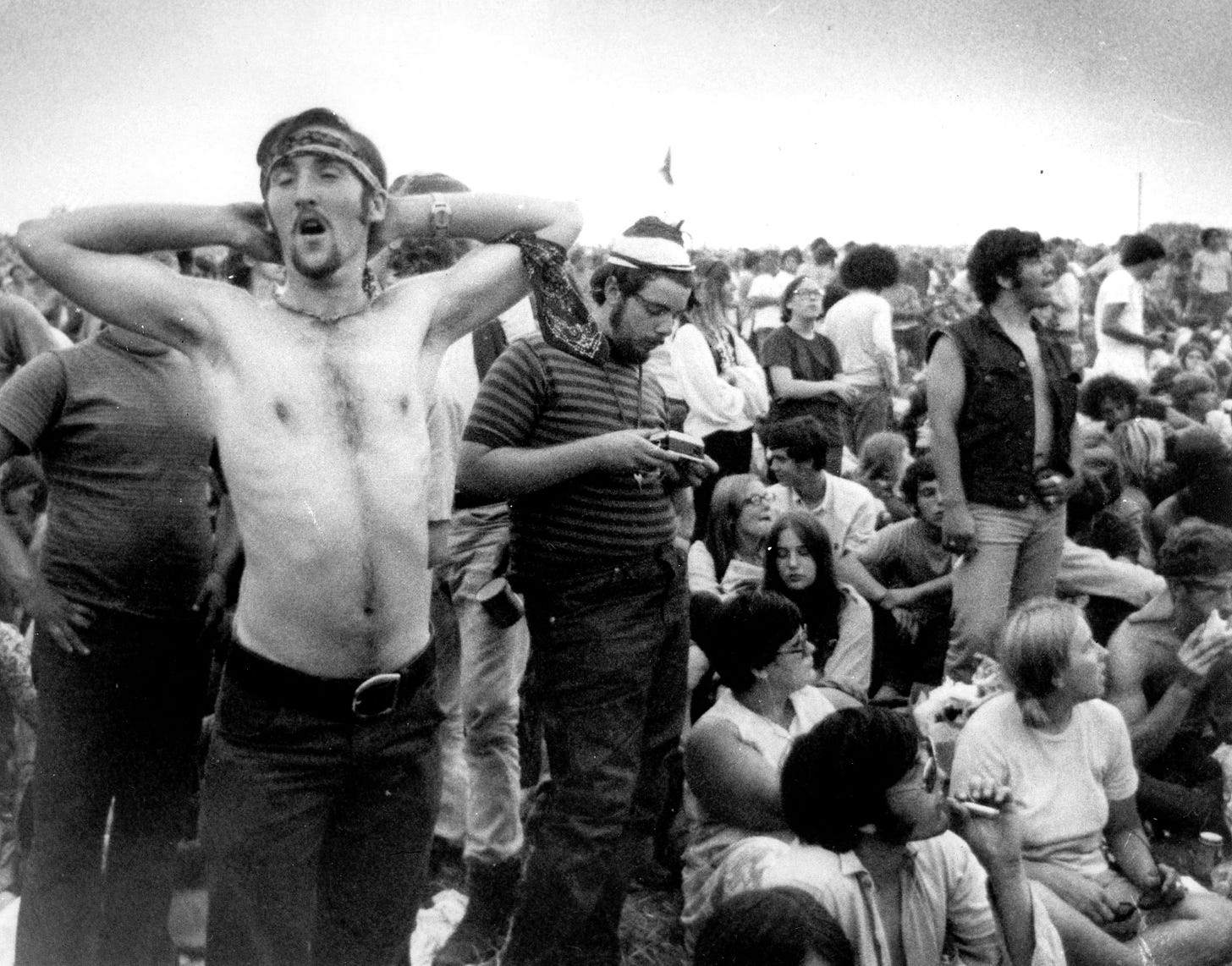 Music fans relax during a break in the entertainment at the Woodstock Music and Arts Fair on Aug. 16, 1969.