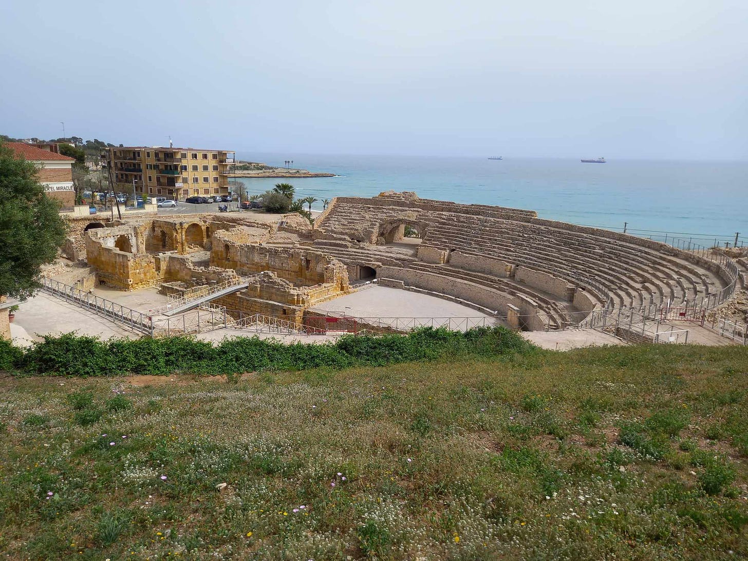 The amphitheater at Tarragona. The church ruins to the left was constructed after the arena stopped being used. Photo my own.