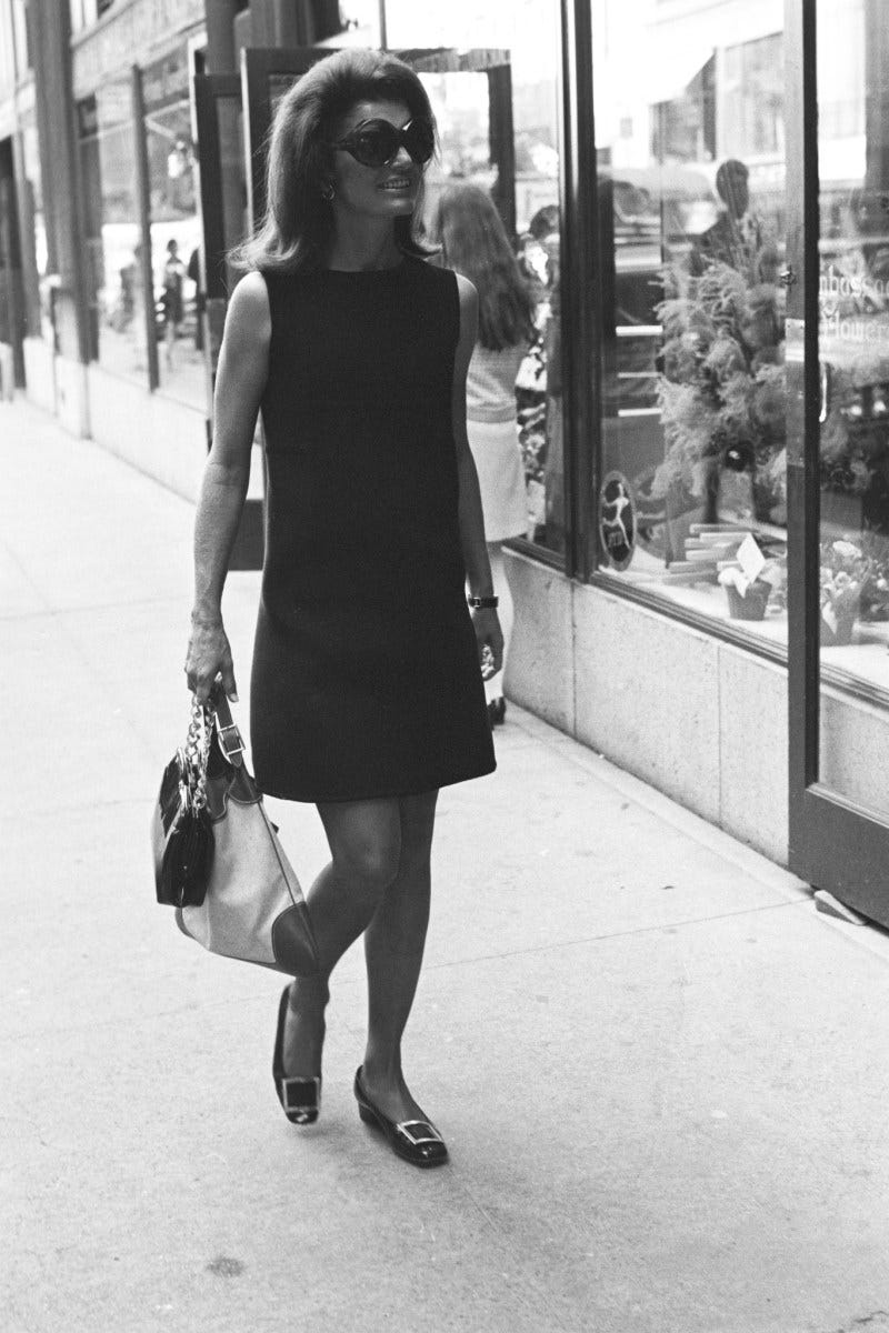 Jacqueline Kennedy Onassis wearing a black dress, sunglasses, and the Gucci "Jackie" handbag in New York on September 18, 1968.
