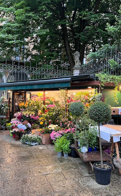 Flower market in Venice during a rain on ancient streets