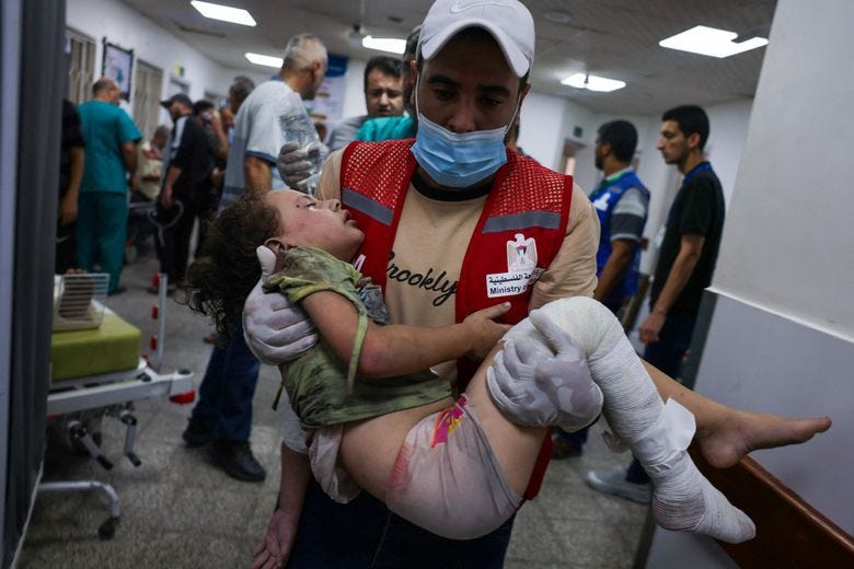 An emergency responder carried a wounded child through a hospital in Rafah, Gaza Strip, on Friday.