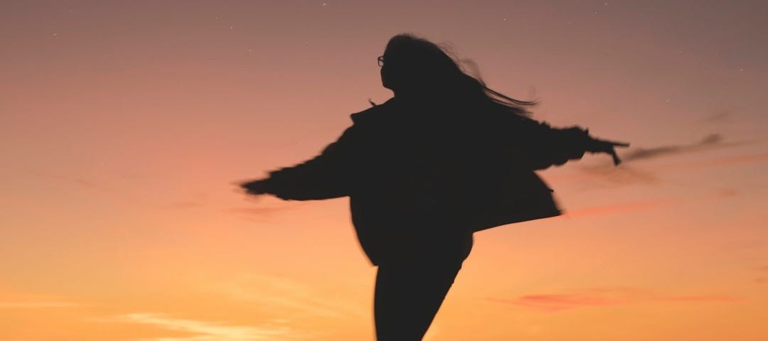 silhouette of woman running during golden hour